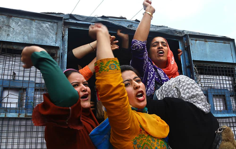 Kashmiri women employees of National Health Mission (NHM) shouts slogans from a police vehicle after being detained during a protest in Srinagar.