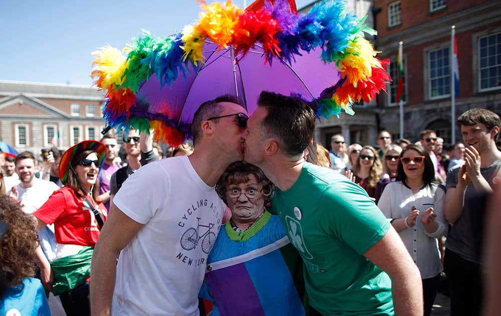 Two men kiss as first results start to filter through in the referendum, Dublin, Ireland. Ireland has voted resoundingly to legalize gay marriage in the world's first national vote on the issue, leaders on both sides of the Irish referendum declared Saturday even as official ballot counting continued.