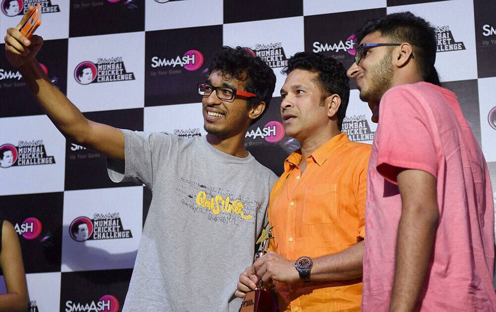 Fans take a selfie with Master Blaster Sachin Tendulkar during Smaaash Mumbai Cricket Challenge felicitation ceremony in Mumbai.