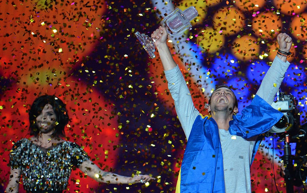 Mans Zelmerlow representing Sweden celebrates with the trophy after winning the final of the Eurovision Song Contest in Austria's capital Vienna.