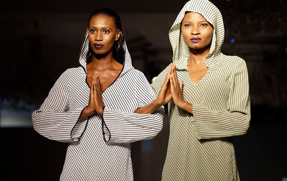 Models strike a pose on the runway during the launching of a new fashion clothing line DENNIZ fashion Limited in Lagos, Nigeria.