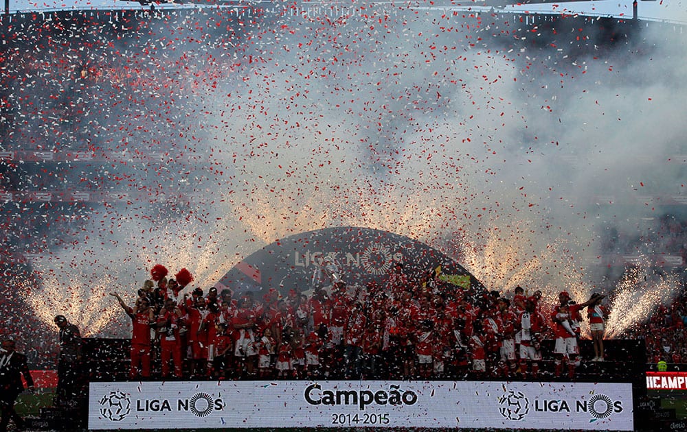 Benfica's players celebrate on the stand at the end of the Portuguese league soccer match between Benfica and Maritimo at the Benfica's Luz stadium, in Lisbon, Portugal.