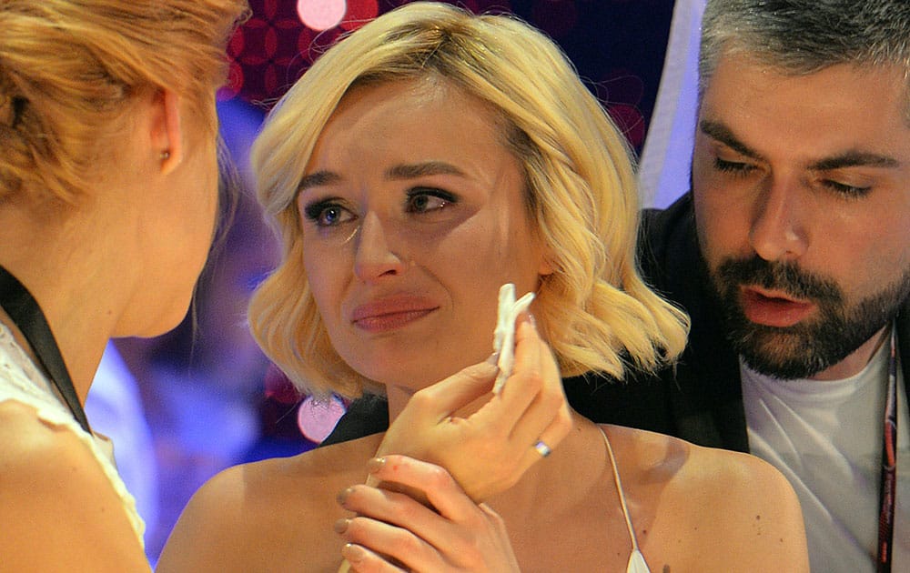 Polina Gagarina representing Russia, centre, reacts as the results start to come in during the final of the Eurovision Song Contest in Austria's capital Vienna.