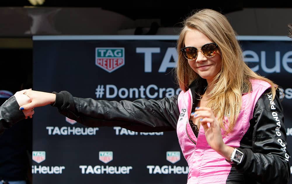 Model Cara Delevingne poses during a photo call at the McLaren pits prior to the start of the Formula One Grand Prix, at the Monaco racetrack, in Monaco.