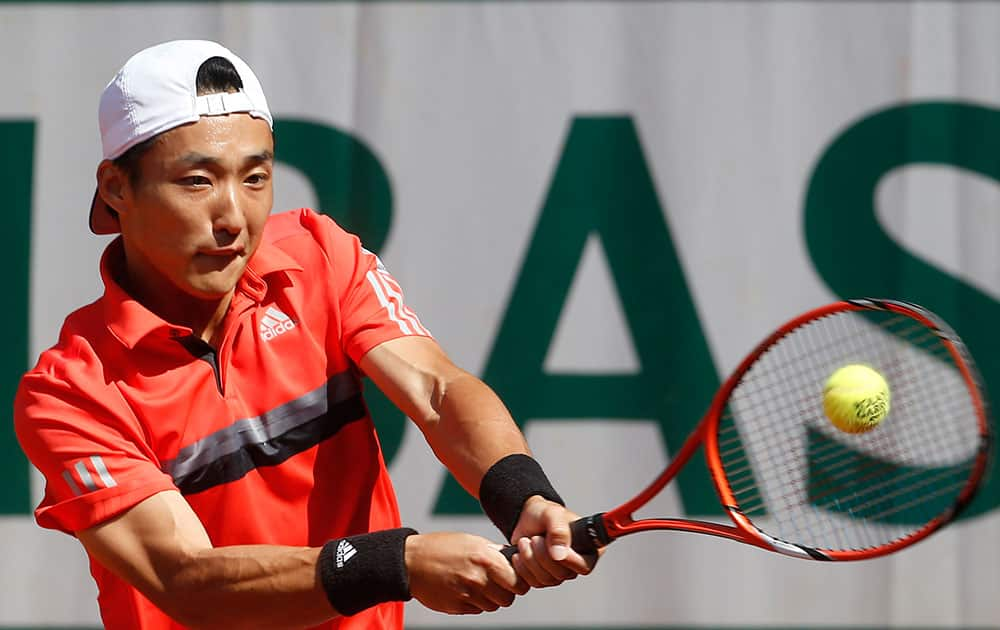 Japan's Go Soeda returns the ball to Germany's Philipp Kohlschreiber during their first round match of the French Open tennis tournament at the Roland Garros stadium.