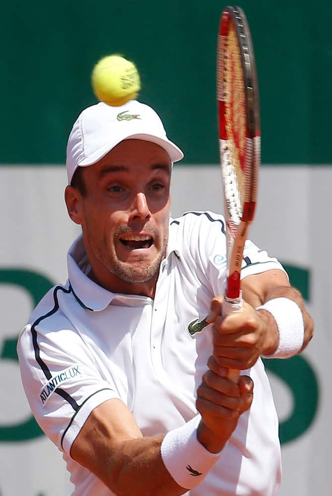 Spain's Roberto Bautista Agut returns the ball to Germany's Florian Mayer during their first round match of the French Open tennis tournament.