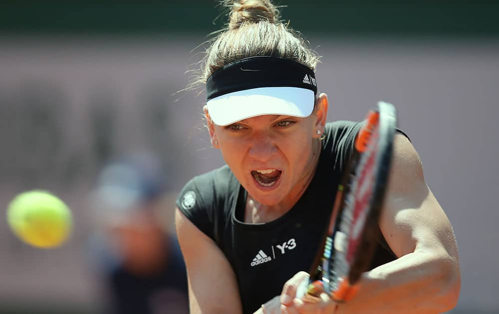 Romania's Simona Halep returns in the first round match of the French Open tennis tournament against Evgeniya Rodina of Russia.