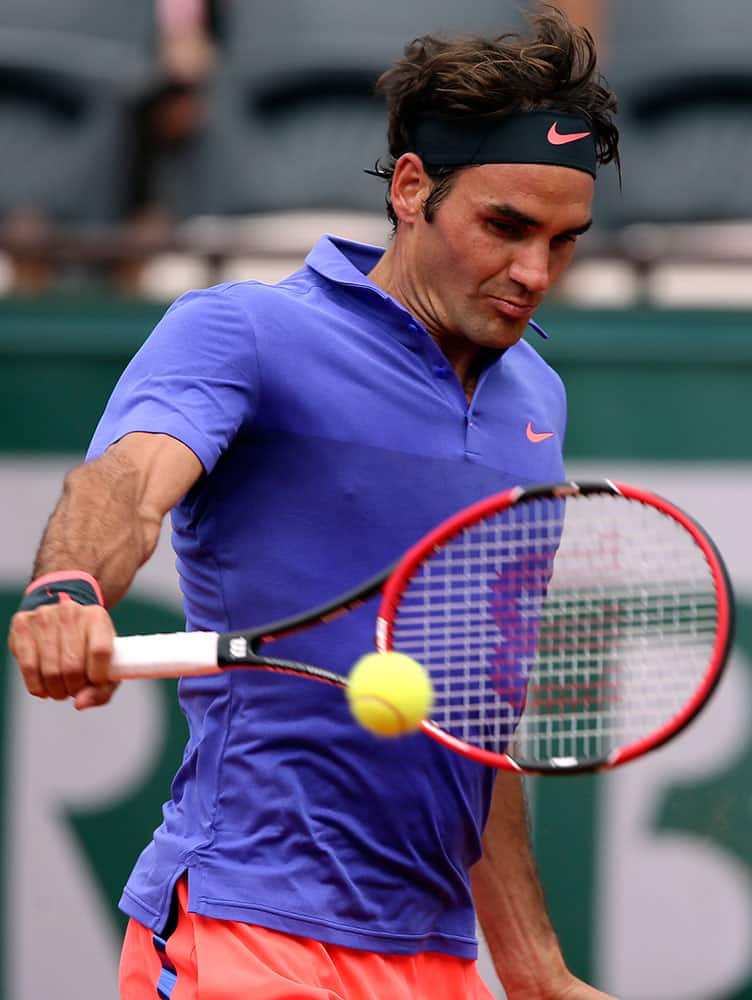 Switzerland's Roger Federer returns the ball to Colombia's Alejandro Falla during their first round match of the French Open tennis tournament.
