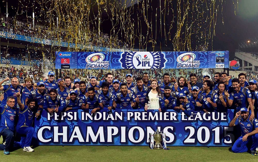 Mumbai Indians players celebrate with trophy after winning IPL8 final against Chennai Super Kings at Eden Garden in Kolkata.