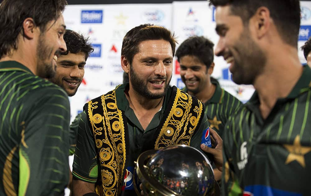 Shahid Afridi, center, captain of the Pakistani cricket team, celebrates the victory with players against Zimbabwe at the Gaddafi Stadium in Lahore, Pakistan.