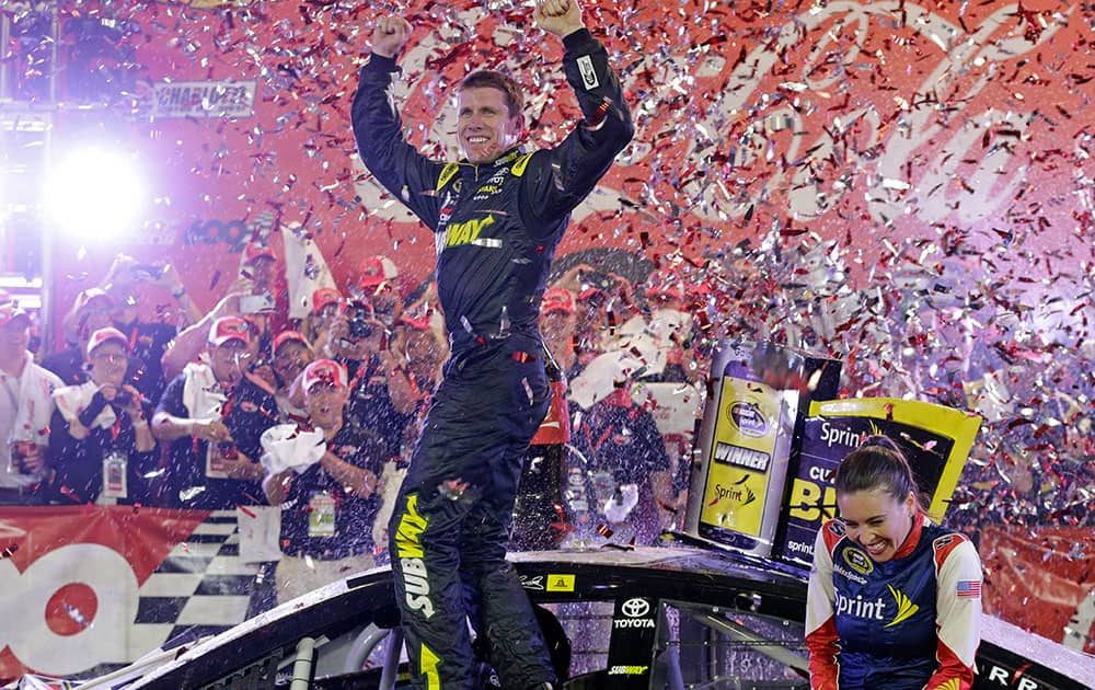 Carl Edwards celebrates in Victory Lane after winning the NASCAR Sprint Cup series auto race at Charlotte Motor Speedway in Concord, N.C.