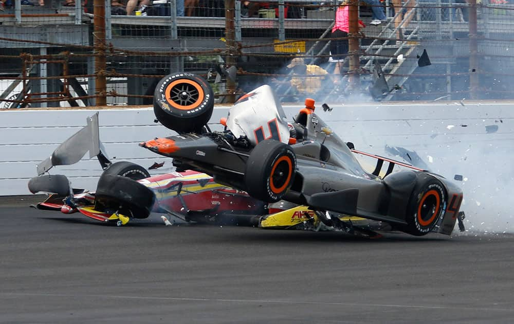 Stefano Coletti, of Monaco, top, hits the car driven by Sebastian Saavedra, of Colombia, in the closing laps of the 99th running of the Indianapolis 500 auto race at Indianapolis Motor Speedway in Indianapolis.