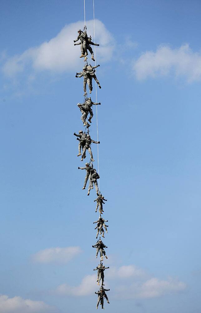 An Army repel team is extracted by a Black Hawk helicopter during a demonstration prior to the NASCAR Sprint Cup series auto race at Charlotte Motor Speedway.