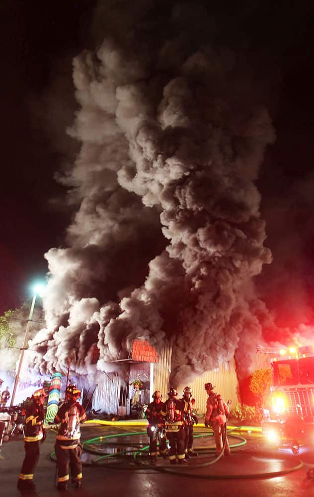 firefighters from several departments assist East Fishkill firefighters in battling a blaze as it consumes the William Tell Hardware store on Route 82 in Hopwell Junction, N.Y. 