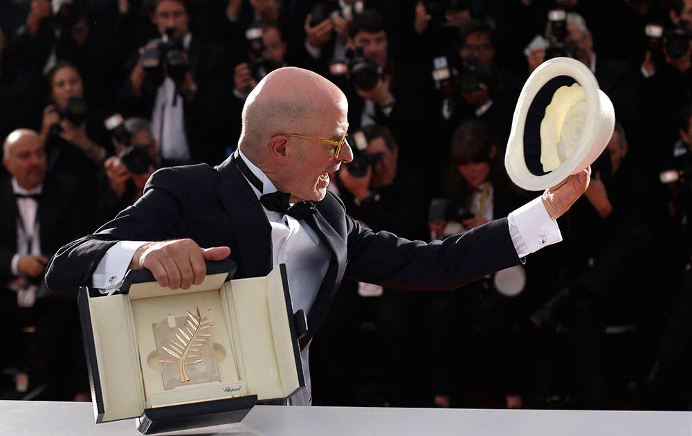 Director Jacques Audiard holds the Palme d’Or award for the film Dheepan during a photo call following the awards ceremony at the 68th international film festival, Cannes.