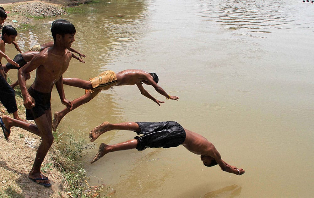 Children jump into the Sirhind Canal in Bathinda to beat the heat.