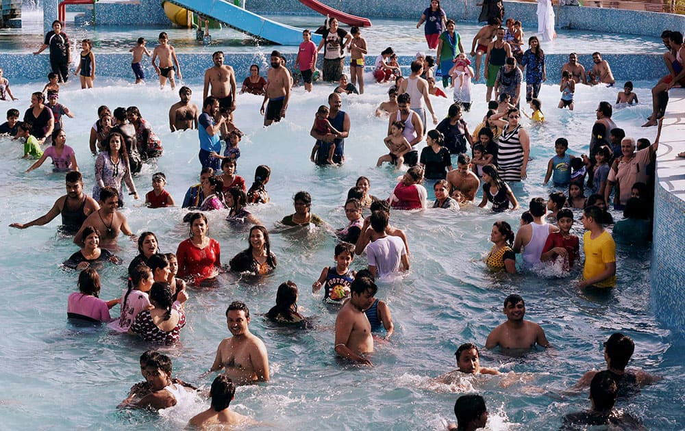 People enjoying in a water park to beat the heat on a hot day in Bhopal.