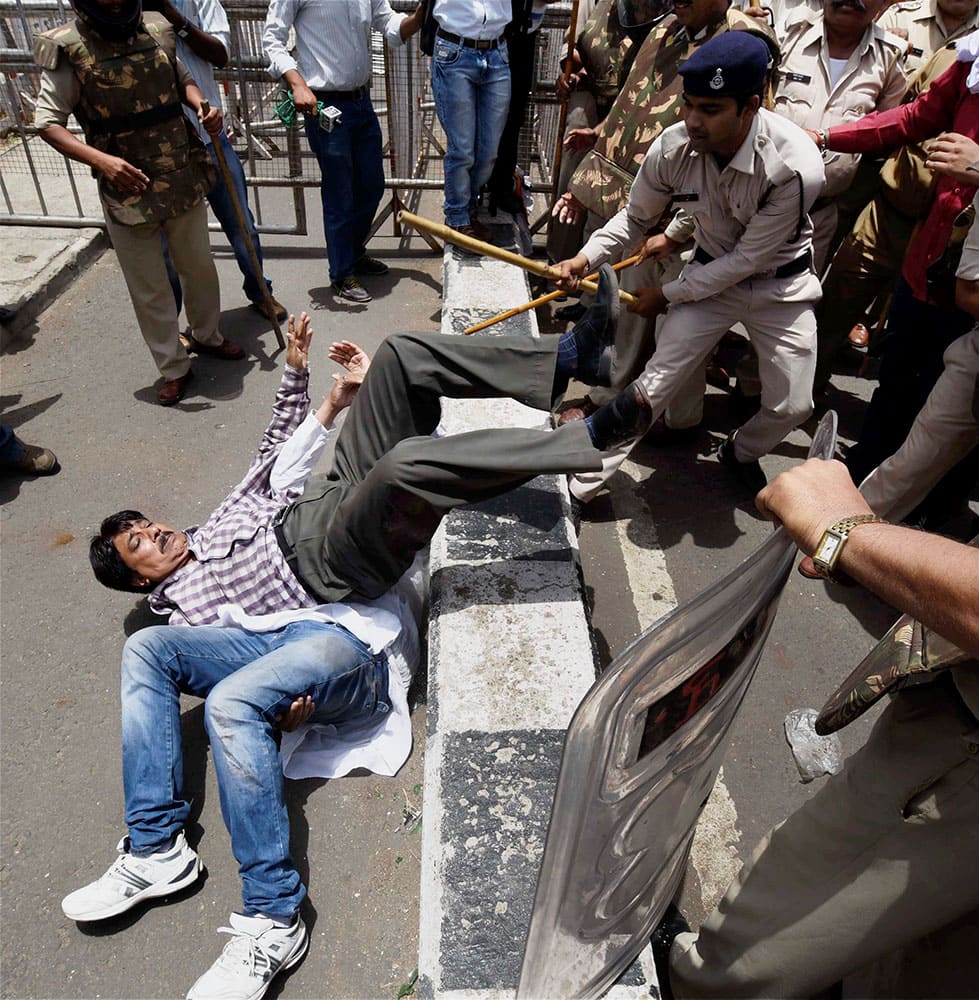 Police charge Congress activists who were staging a protest at the residence of Madhya Pradesh Chief Minister Shivraj Singh Chouhan in Bhopal.