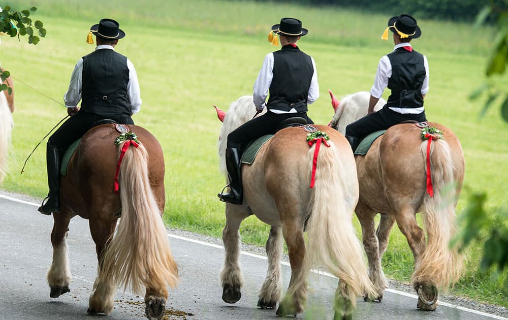 Participants of the Pentecost Ride ride on their horses near Bad Koetzting, Germany.