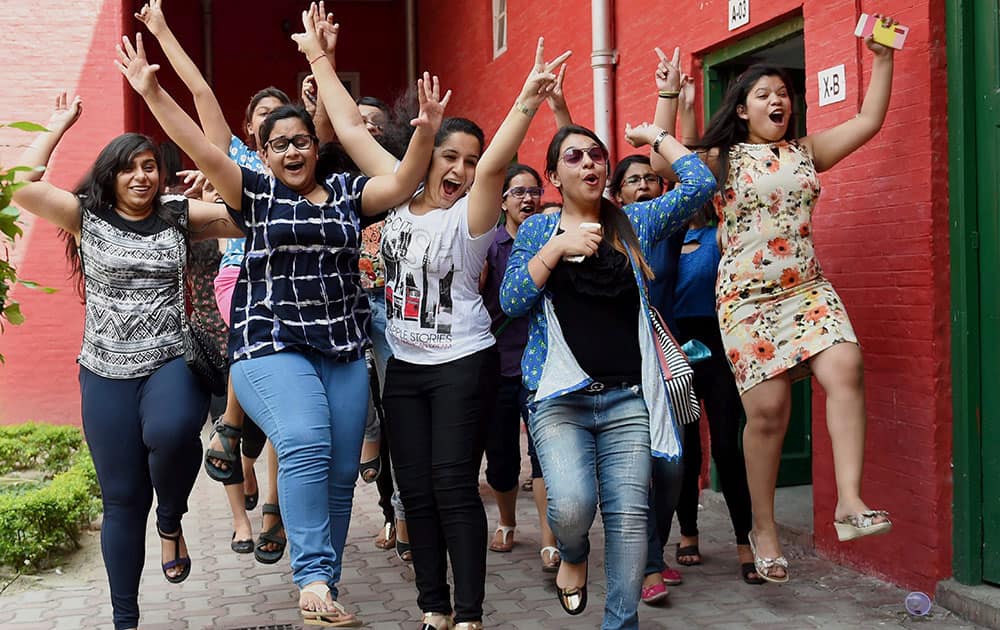 Students celeberate their success at a school after CBSE announced its 12th class results in New Delhi.