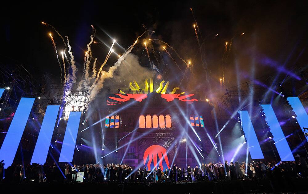 Fireworks explode behind the government house during the celebration of the 25 of May holiday at Plaza de Mayo in Buenos Aires, Argentina.