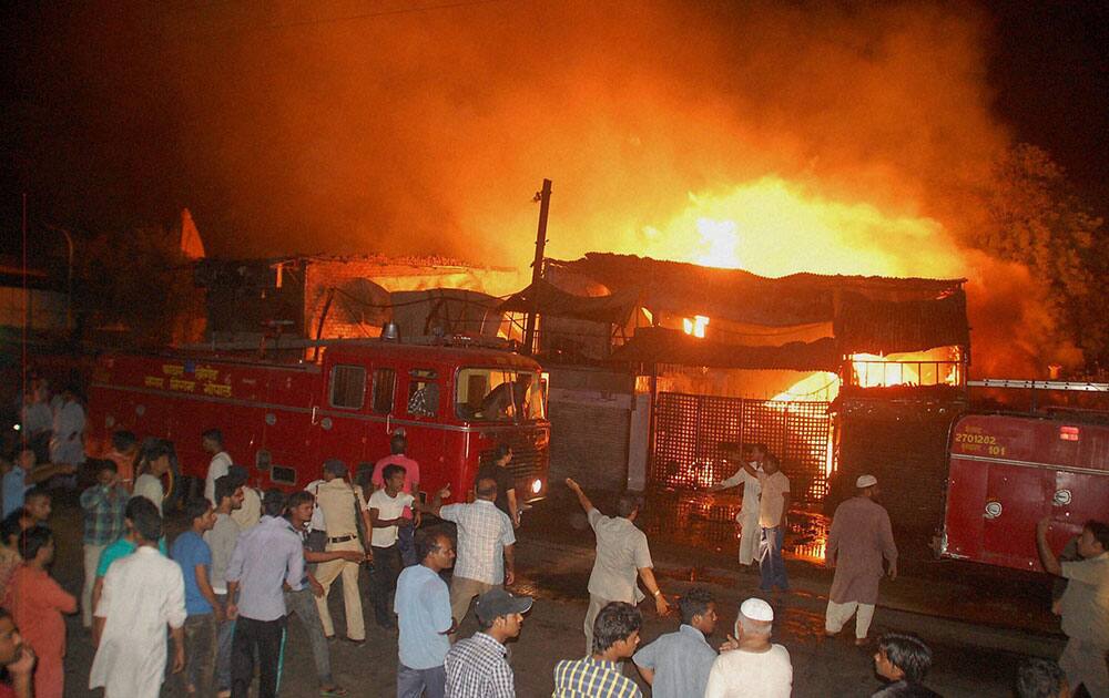 Firemen extinguishing fire in a saw mill in Bhopal on Sunday night. 