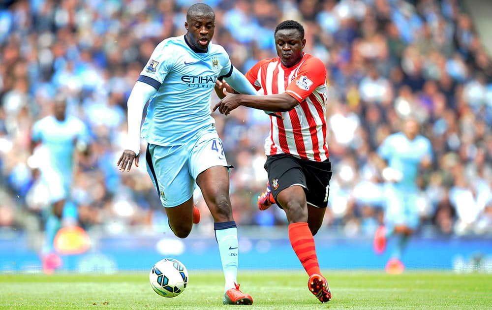 Manchester City's Yaya Toure, left, and Southampton's Victor Wanyama battle for the ball during the English Premier League soccer match at the Etihad Stadium, Manchester, England.