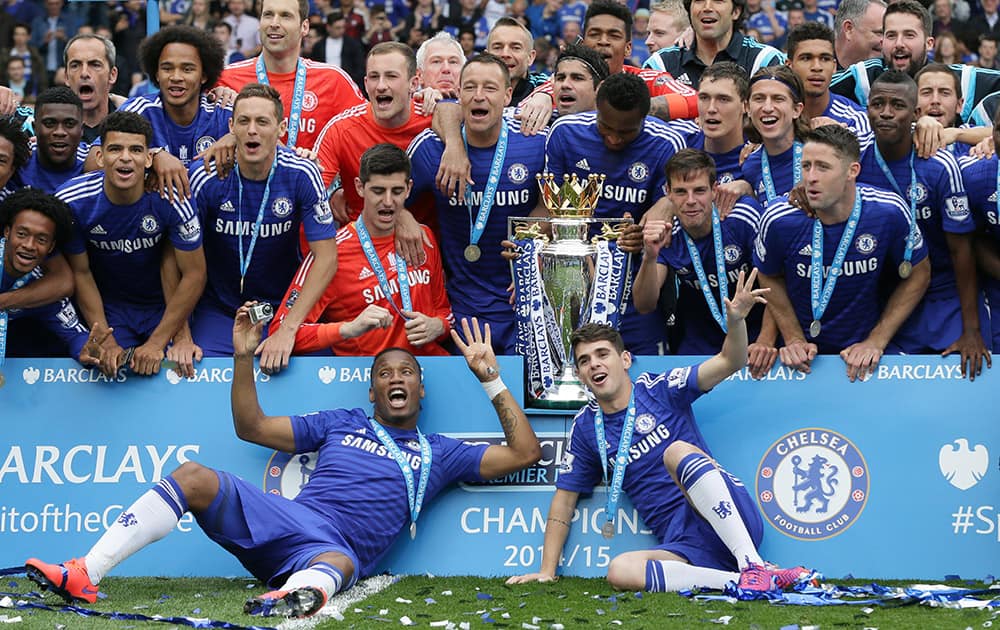 Chelsea players celebrate with the trophy after the English Premier League soccer match between Chelsea and Sunderland at Stamford Bridge stadium in London.