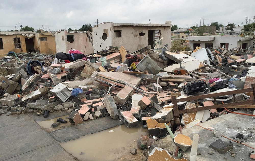 Damaged homes stand next to others that were razed when a powerful tornado touched down. The tornado raged through the city on the US-Mexico border. 