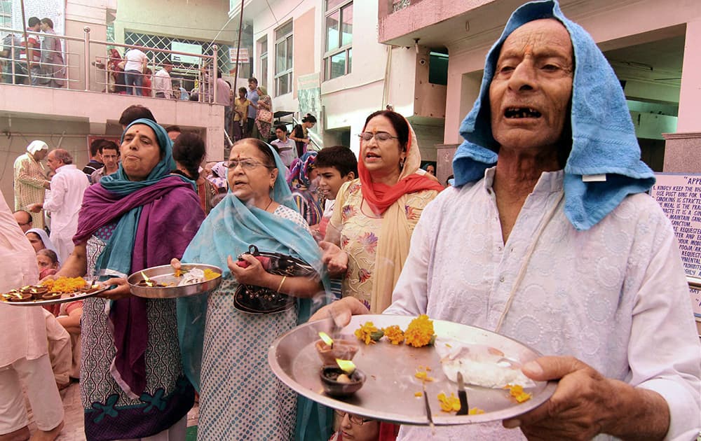 Kashmiri Pandits offer prayers at the Kheer Bhawani temple in Jammu on the occasion of the Kheer Bhawani Mela.