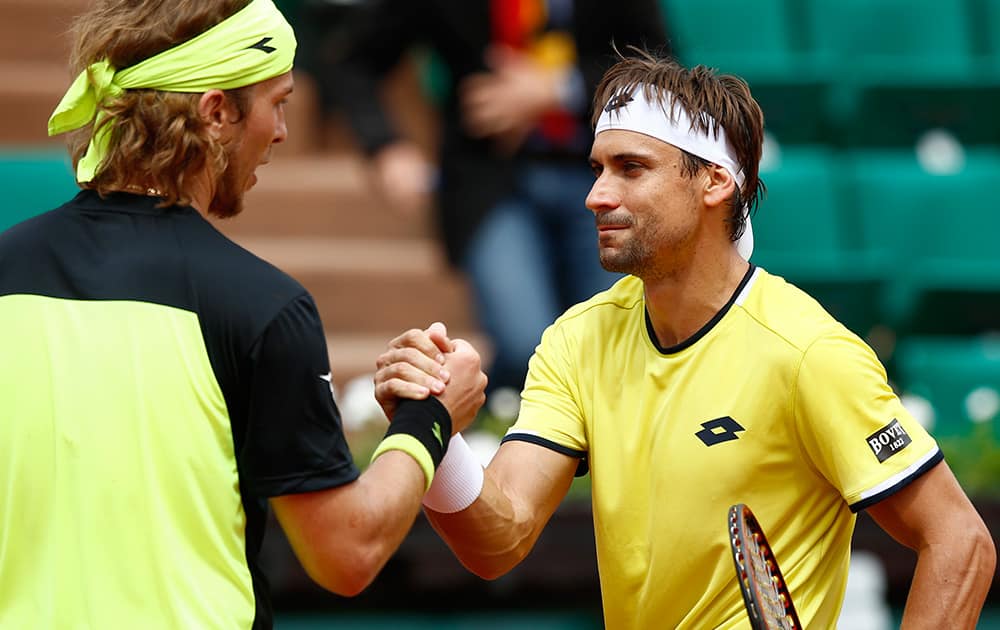 Spain's David Ferrer, right, shakes hands with Slovakia's Lukas Lacko after their first round match of the French Open tennis tournament at the Roland Garros stadium in Paris. Ferrer won 6-1, 6-3, 6-1.