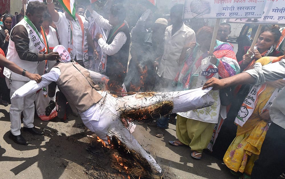 Congress workers burn an effigy of Prime Minister Narendra Modi during a protest at Malad in Mumbai on the first anniversary of the NDA Government.
