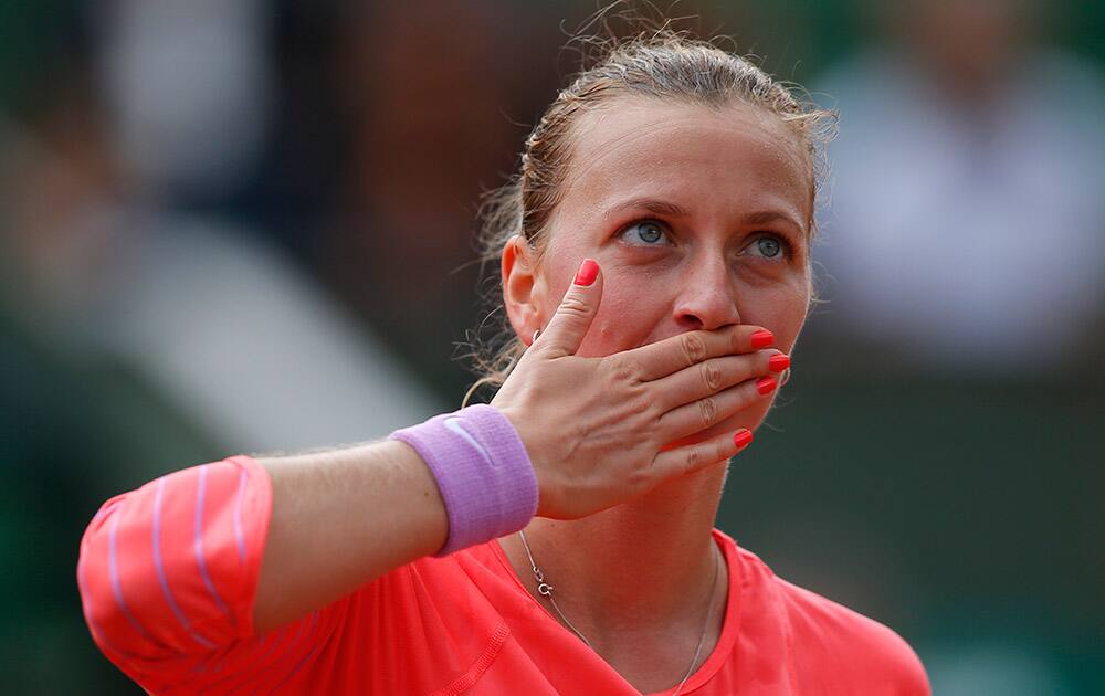 Petra Kvitova of the Czech Republic blows a kiss to the public after defeating New Zealand's Marina Erakovic during their first round match of the French Open tennis tournament at the Roland Garros stadium in Paris. Kvitova won 6-4, 3-6, 6-4.