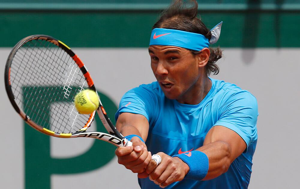 Spain's Rafael Nadal returns in the first round match of the French Open tennis tournament against Quentin Halys of France at the Roland Garros stadium, in Paris, France.