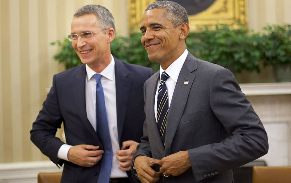 President Barack Obama and NATO Secretary General Jens Stoltenberg, get up from their seats following their meeting, in the Oval Office of the White House in Washington. 