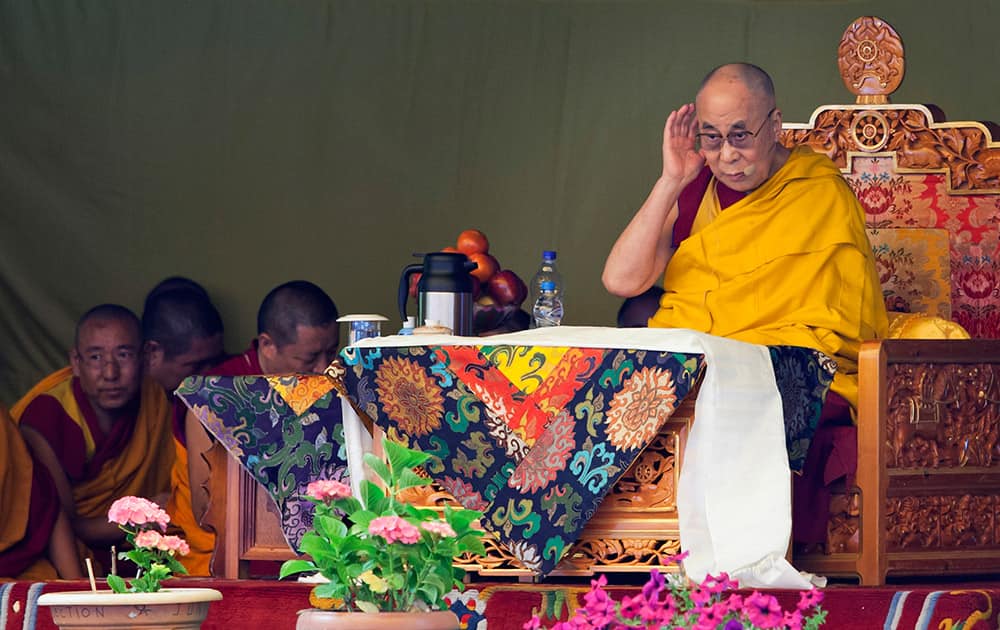 Tibetan spiritual leader the Dalai Lama listens to a debate on Tibetan Buddhist dialectics presented by students at the Tibetan Children's Village School in Dharmsala. Every year Dalai Lama gives teachings to young Tibetans at the school.