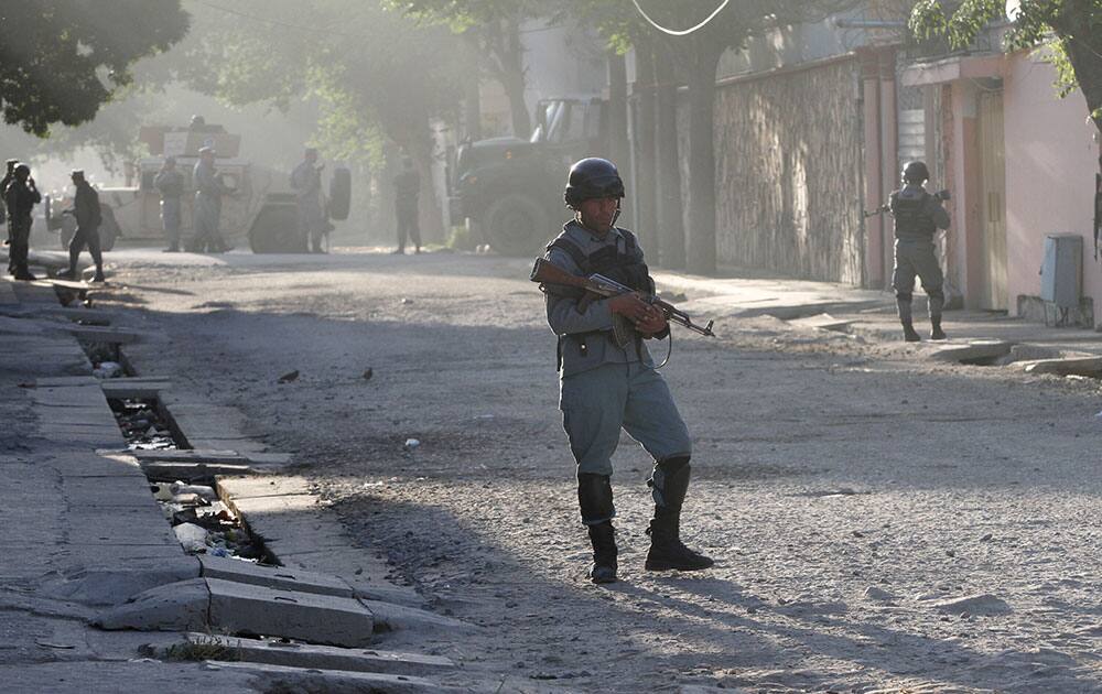 Afghan security officers patrol near a guesthouse targeted in an attack by the Taliban, in Kabul, Afghanistan.  An all-night siege in an upscale neighborhood of Afghanistan's capital ended in the early hours of Wednesday morning with the deaths of four heavily armed Taliban attackers, though no civilians or security personnel were injured or killed, an Afghan official said. 