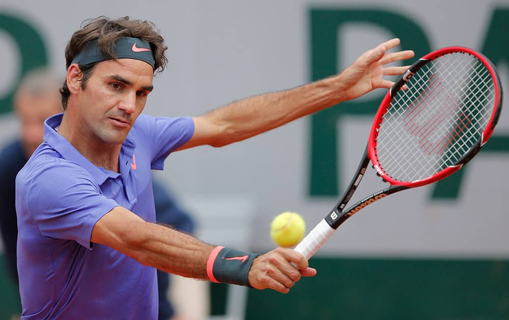 Switzerland's Roger Federer returns in the second round match of the French Open tennis tournament against Spain's Marcel Granollers at the Roland Garros stadium, in Paris.