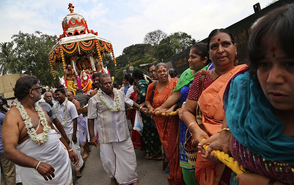 Devotees pull the rope to move the silver chariot carrying an idol of Hindu god Balaji during the annual festival of Kote Venkatramana temple in Bangalore. The 17th Century temple festival is one of the oldest continuously celebrated festivals of Bangalore.