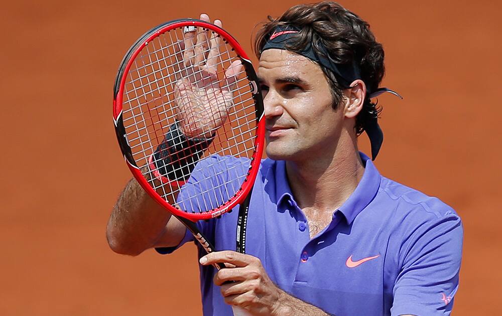 Switzerland's Roger Federer thanks the audience after defeating Spain's Marcel Granollers during their second round match of the French Open tennis tournament at the Roland Garros stadium in Paris.