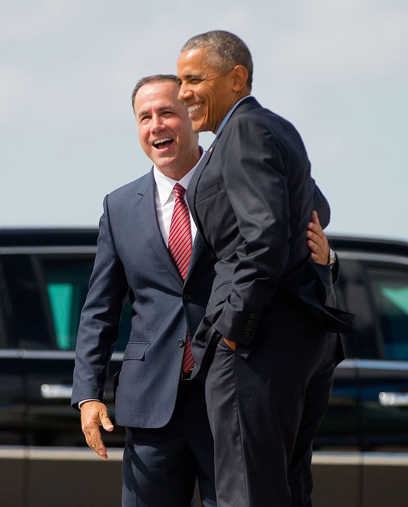 President Barack Obama is greeted by Miami Beach, Fla. Mayor Philip Levine upon his arrival on Air Force One at Miami International Airport.