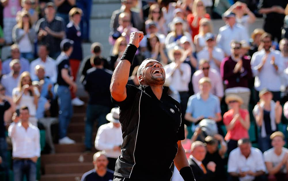 France's Jo-Wilfried Tsonga celebrates after defeating Israel's Dudi Sela in their second round match of the French Open tennis tournament at the Roland Garros stadium in Paris.