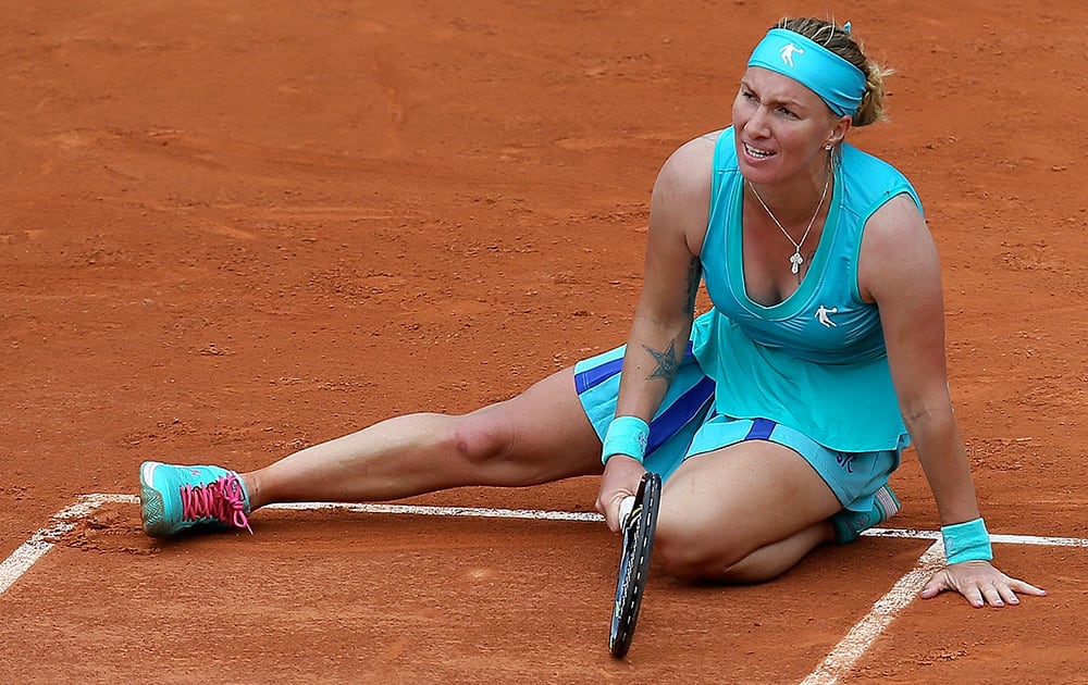 Russia's Svetlana Kuznetsova falls on the clay as she plays Italy's Francesca Schiavone during their second round match of the French Open tennis tournament at the Roland Garros stadium in Paris. Schiavone won 6-7, 7-5, 10-8 in 3 hours and 50 minutes.