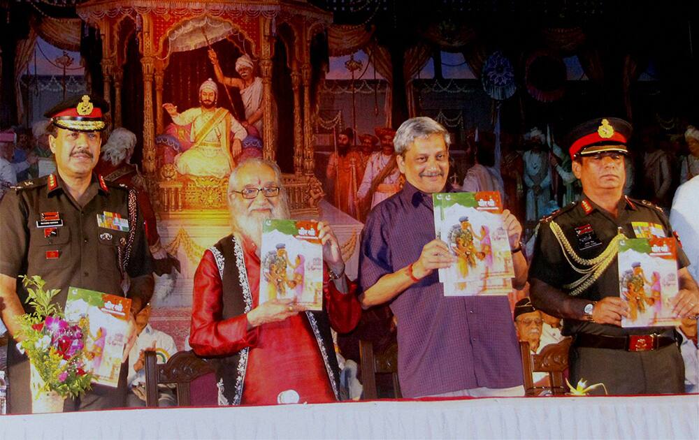 Defence Minister Manohar Parrikar releases a booklet during a Sainik Samman Samaroh in Pune.