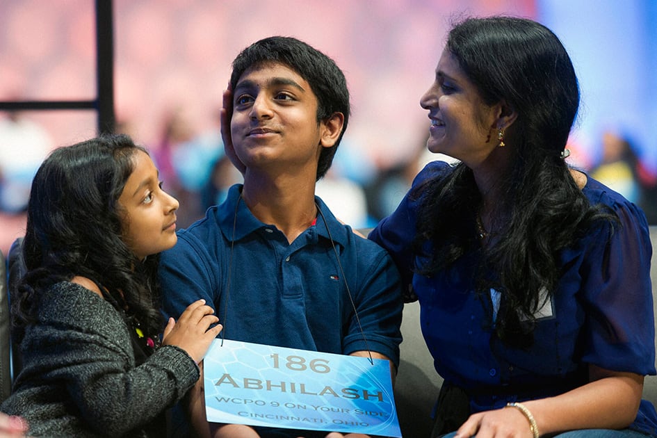 Abhilash Yarlagadda, 13, of Cincinnati, Ohio, is comforted by his sister Nmaamasa Yarlagadda, left, and mother Sunitha Yarlagadda after misspelling the word cataphyll during the 2015 Scripps National Spelling Bee in Oxon Hill, Md.