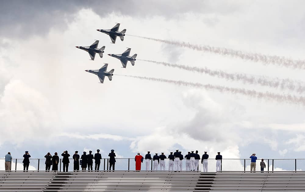 F-16 jets from the Thunderbirds make a flyover following the completion of the Air Force Academy graduation ceremony for the class of 2015, at the US Air Force Academy, in Colorado Springs, Colo.