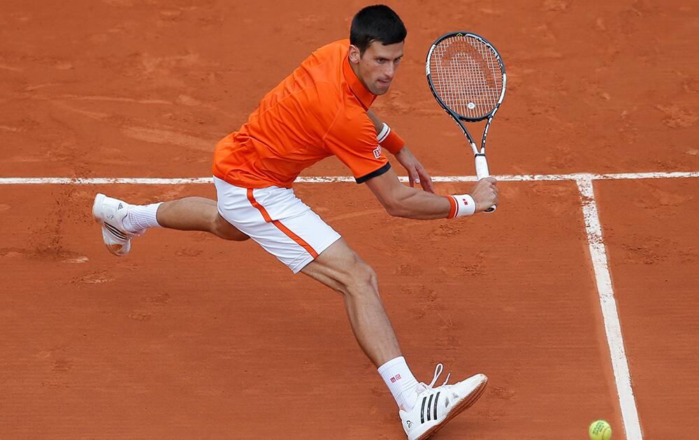 Serbia's Novak Djokovic returns in the second round match of the French Open tennis tournament against Luxembourg's Gilles Muller at the Roland Garros stadium, in Paris, France.