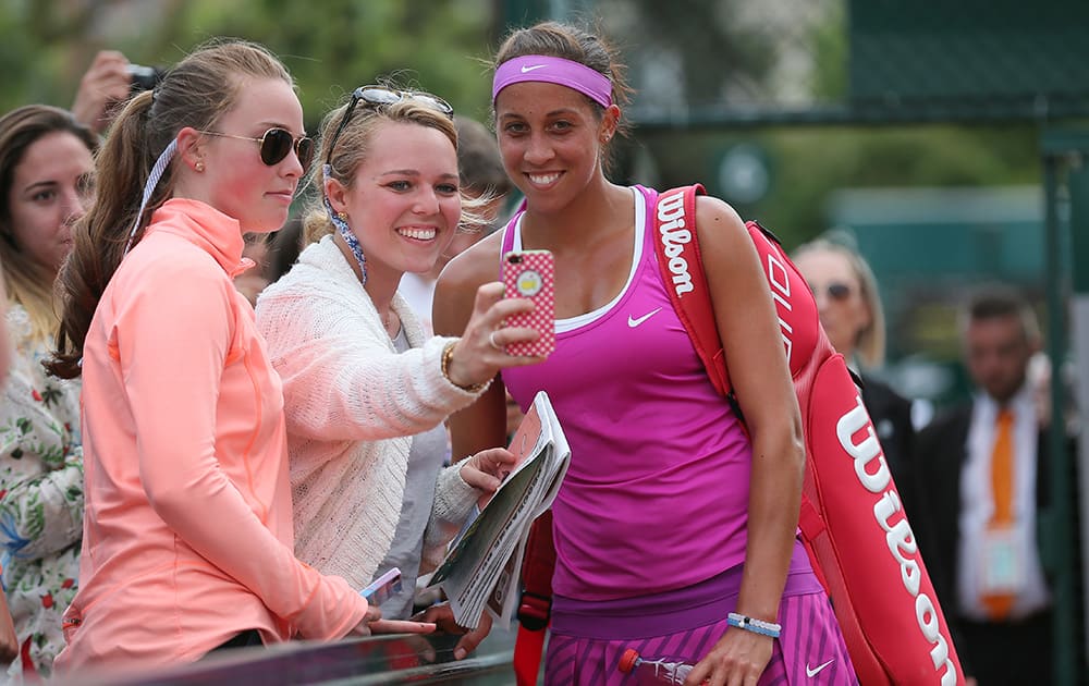 Madison Keys of the US poses for selfie with tennis lovers after defeating Belinda Bencic of Switzerland in their second round match of the French Open tennis tournament at the Roland Garros stadium.