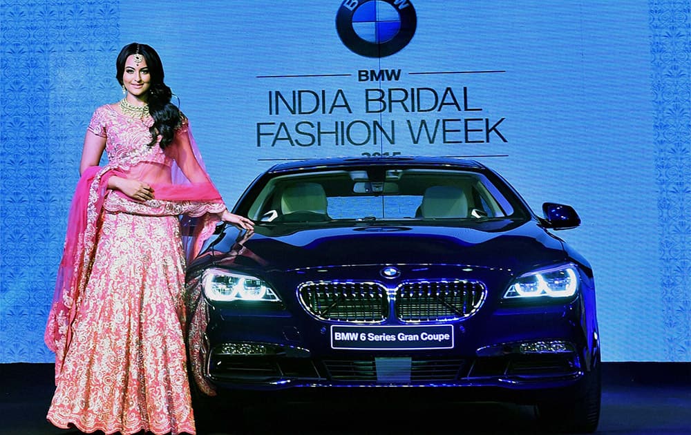 Sonakshi Sinha poses next to the newly launched BMW 6 Series Gran Coupe at BMW India Bridal Fashion Week in New Delhi.