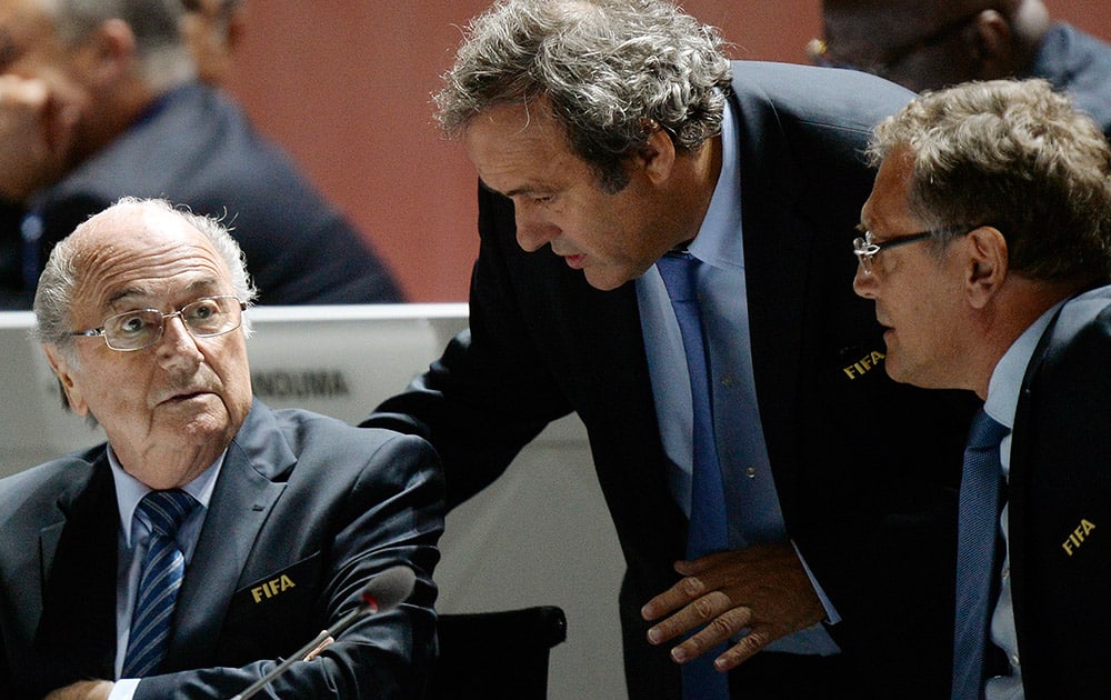 FIFA President Joseph S. Blatter, left, UEFA President Michel Platini, center, and FIFA Secretary General Jerome Valcke, right, are engaged in conversation during the 65th FIFA Congress held at the Hallenstadion in Zurich, Switzerland.